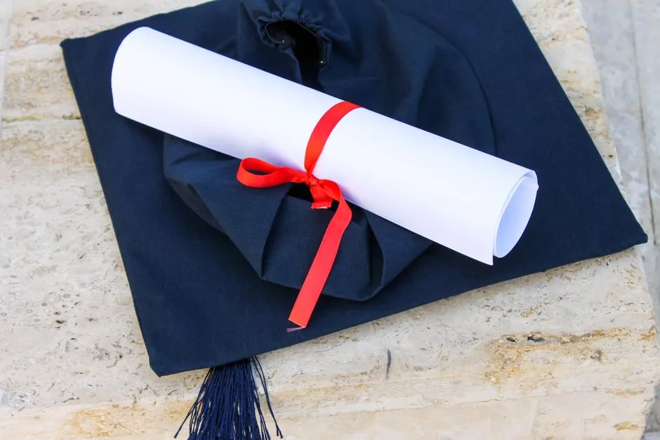 Academic cap and rolled diploma, symbolizing achievement recognition
